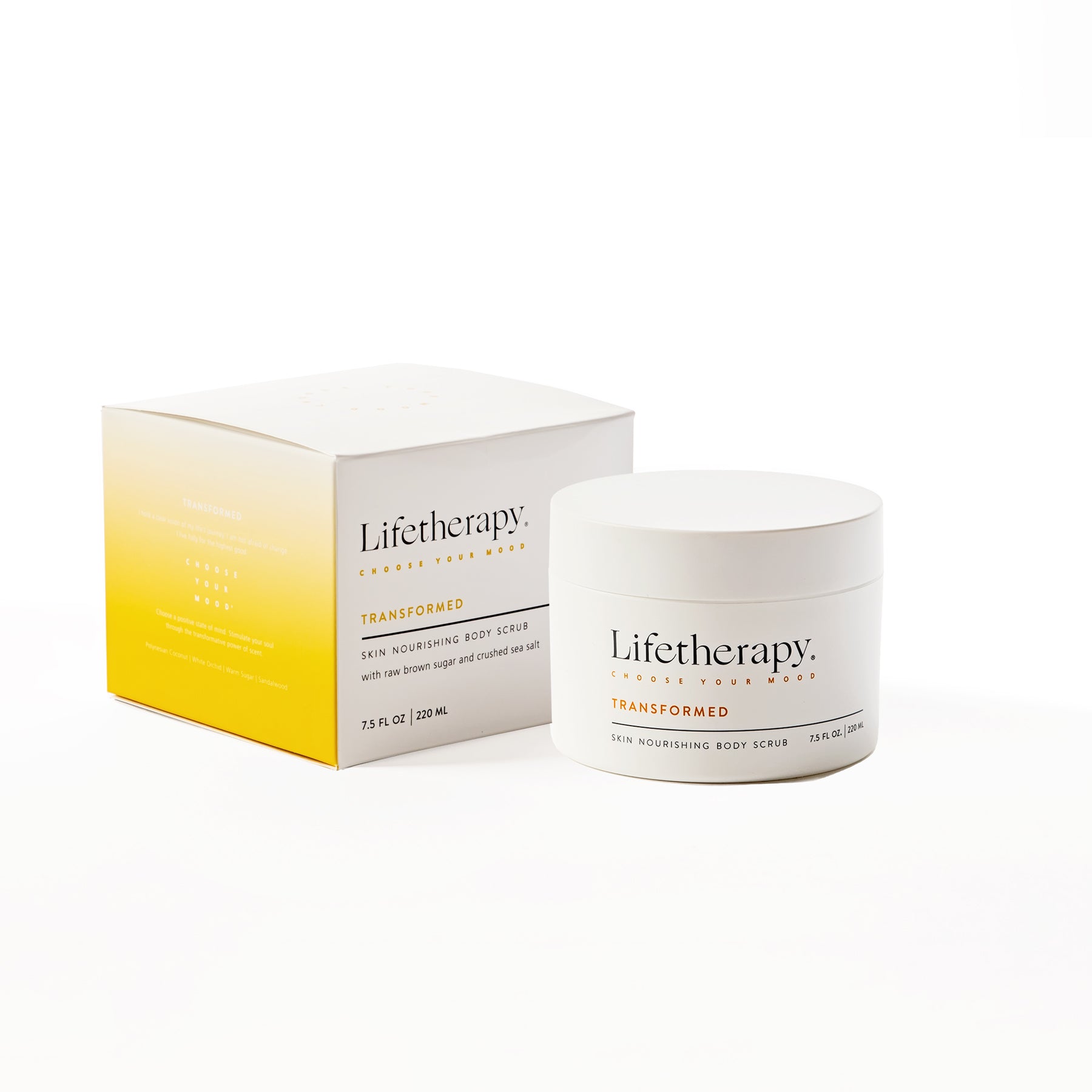 Transformed Lifetherapy exfoliating scrub jar with a bamboo spoon, featuring coconut and sandalwood fragrance notes. Shown with soft touch packaging box. 
